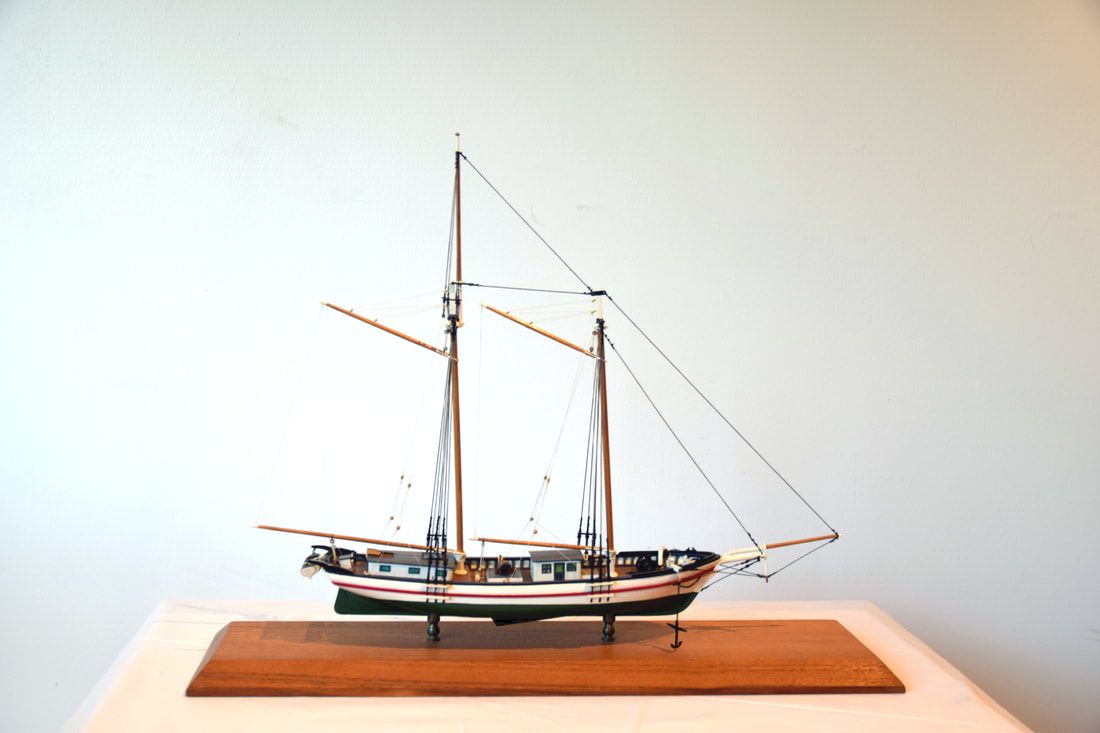Model of the schooner Clipper, mounted on a wooden base, photographed on a white background